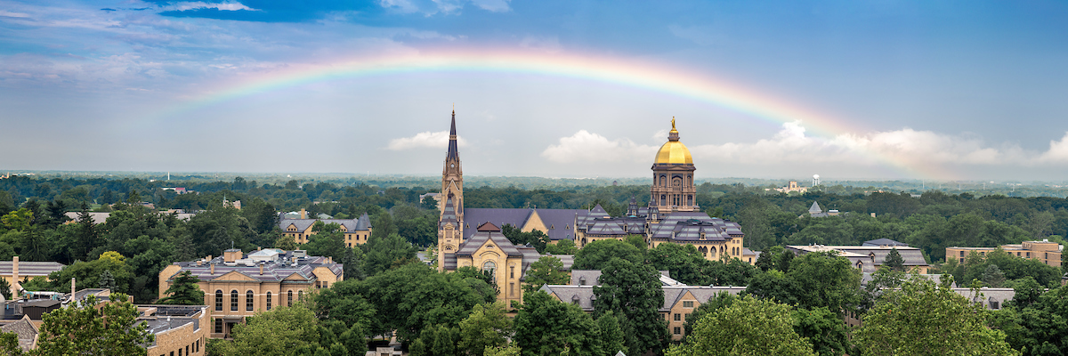 A panoramic view of campus with a rainbow stretching from end to end